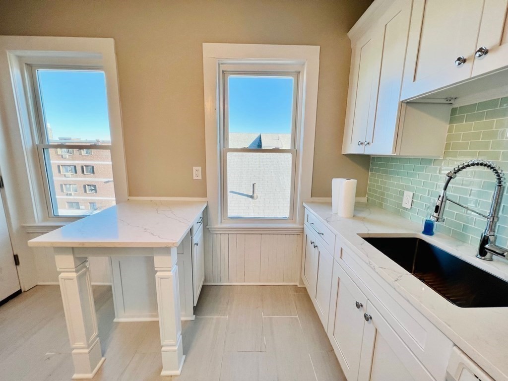 22 Gardena Street, Unit 3 Boston, MA 02135 - Photo 5 of 17 a kitchen with a sink stove and cabinets