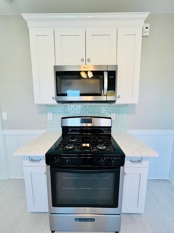 22 Gardena Street, Unit 3 Boston, MA 02135 - Photo 6 of 17 a stove top oven sitting inside of a kitchen