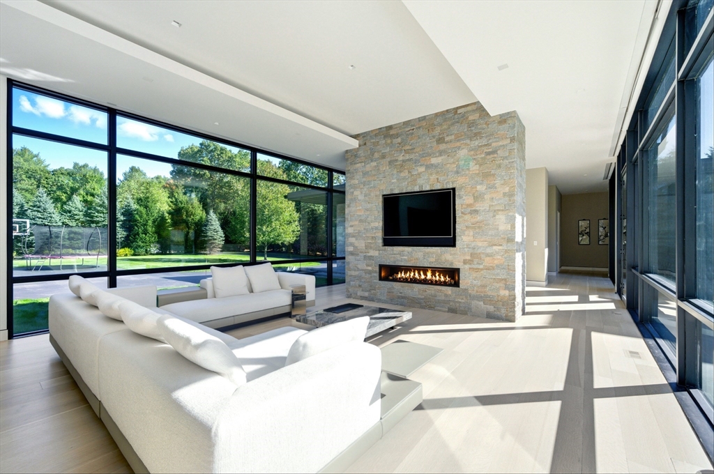 63 Sylvan Lane Weston, MA 02493 - Photo 13 of 28 a living room with patio furniture and a flat screen tv