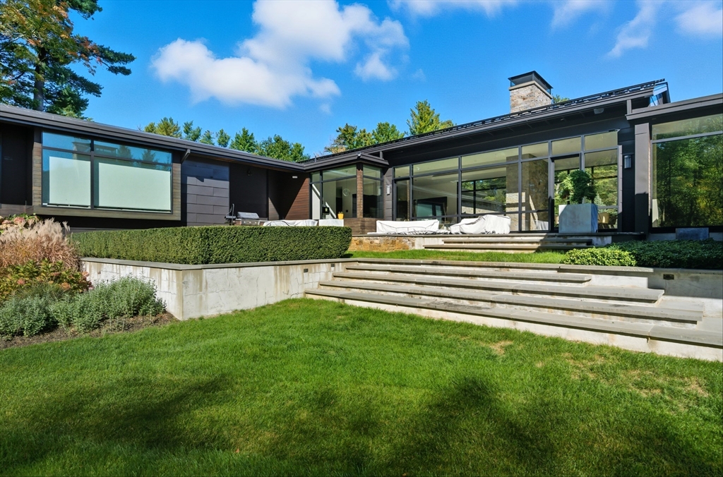 63 Sylvan Lane Weston, MA 02493 - Photo 23 of 28 a front view of a house with a garden