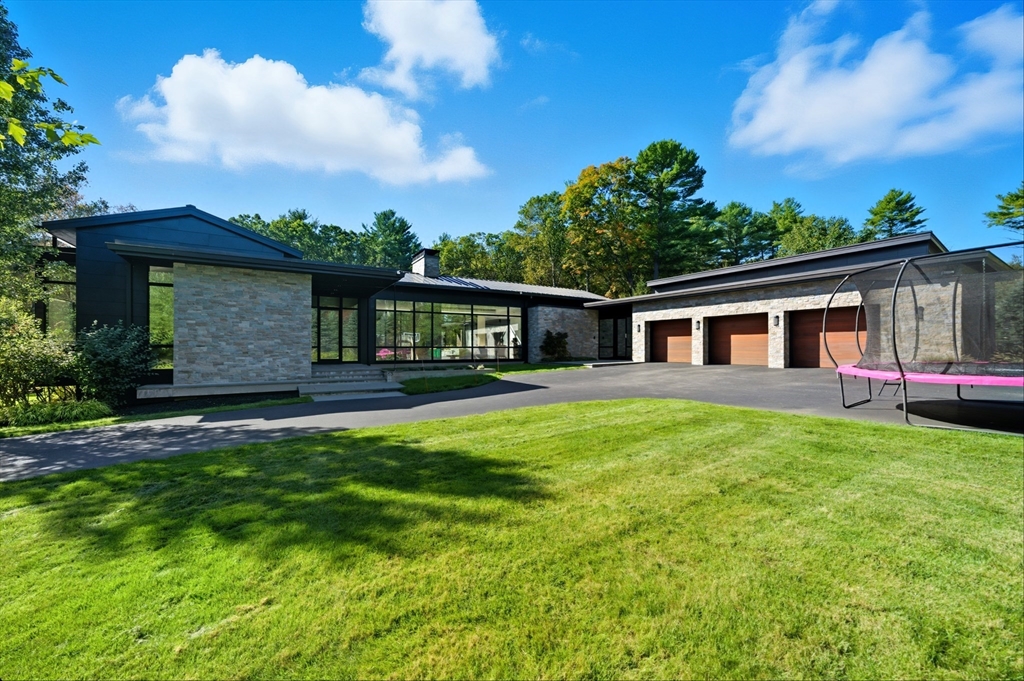 63 Sylvan Lane Weston, MA 02493 - Photo 26 of 28 a front view of house with yard and trees in the background
