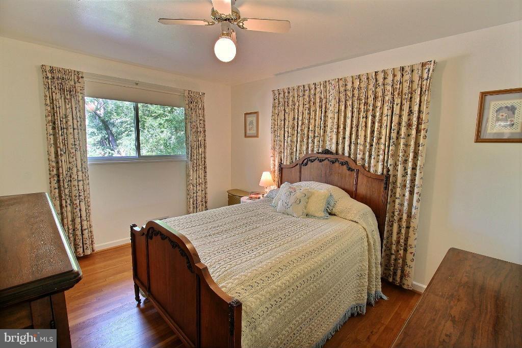 12902 Goodhill Road Silver Spring, MD 20906 - Photo 12 of 20 a bed sitting in a bedroom next to a window