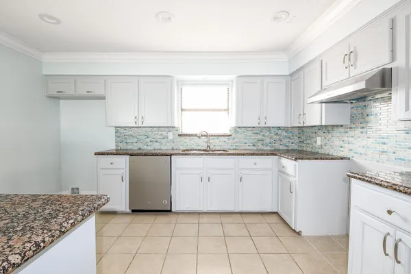 a kitchen with stainless steel appliances granite countertop a sink stove and cabinets