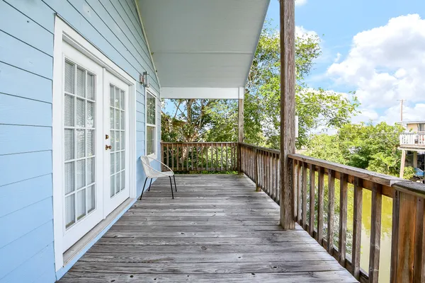 a view of a balcony with wooden floor
