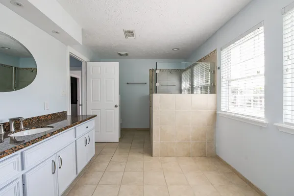 a large white kitchen with a large window