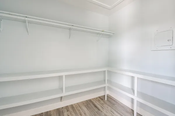 a view of walk in closet with empty racks