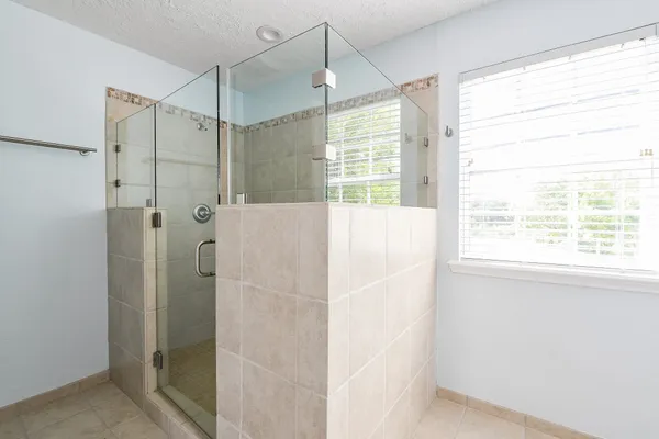 a bathroom with a shower and a window