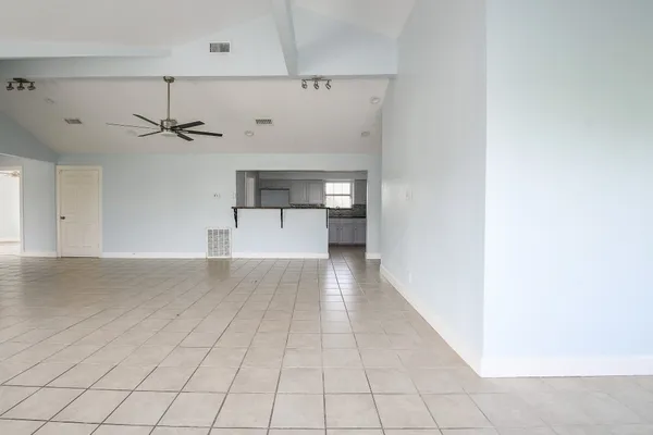 a view of a kitchen with wooden cabinet and a hallway