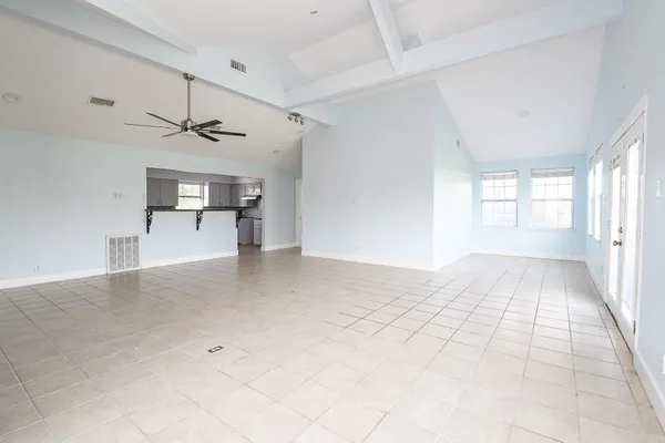 a view of empty room with wooden floor and window