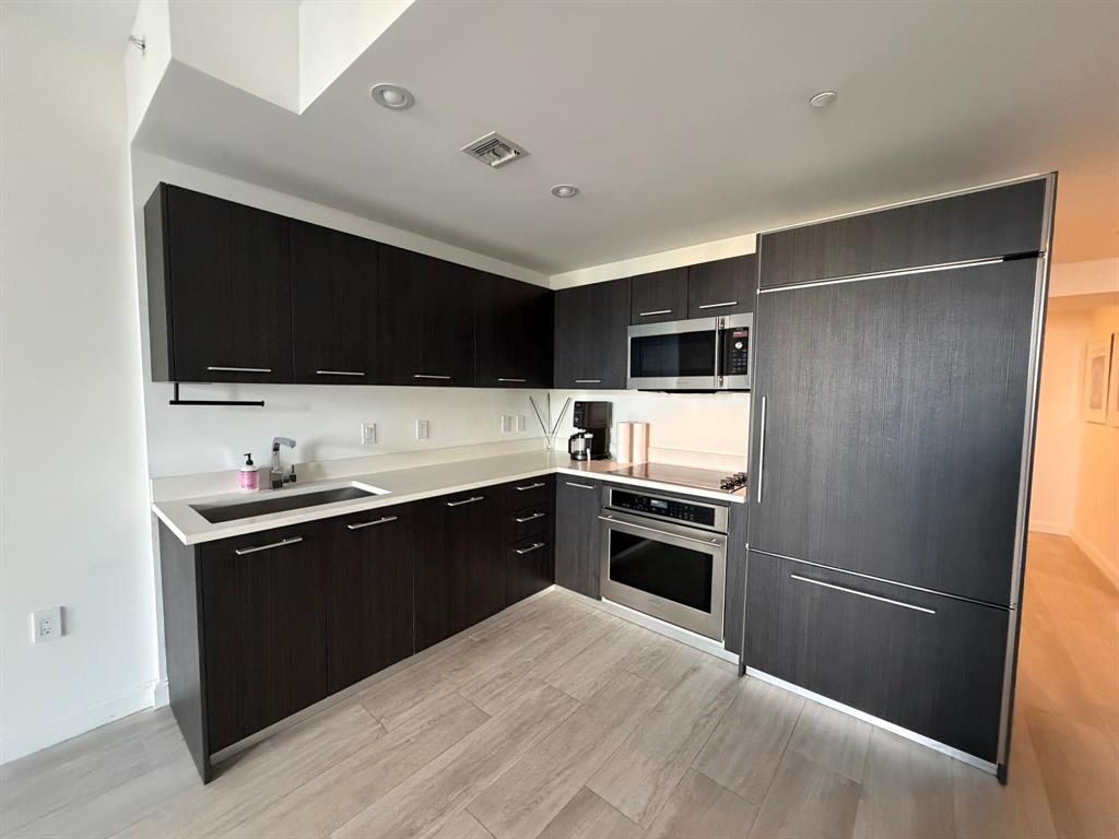 45 Southwest 9th Street, Unit 3110 Miami, FL 33130 - Photo 12 of 19 a kitchen with a refrigerator stove and microwave