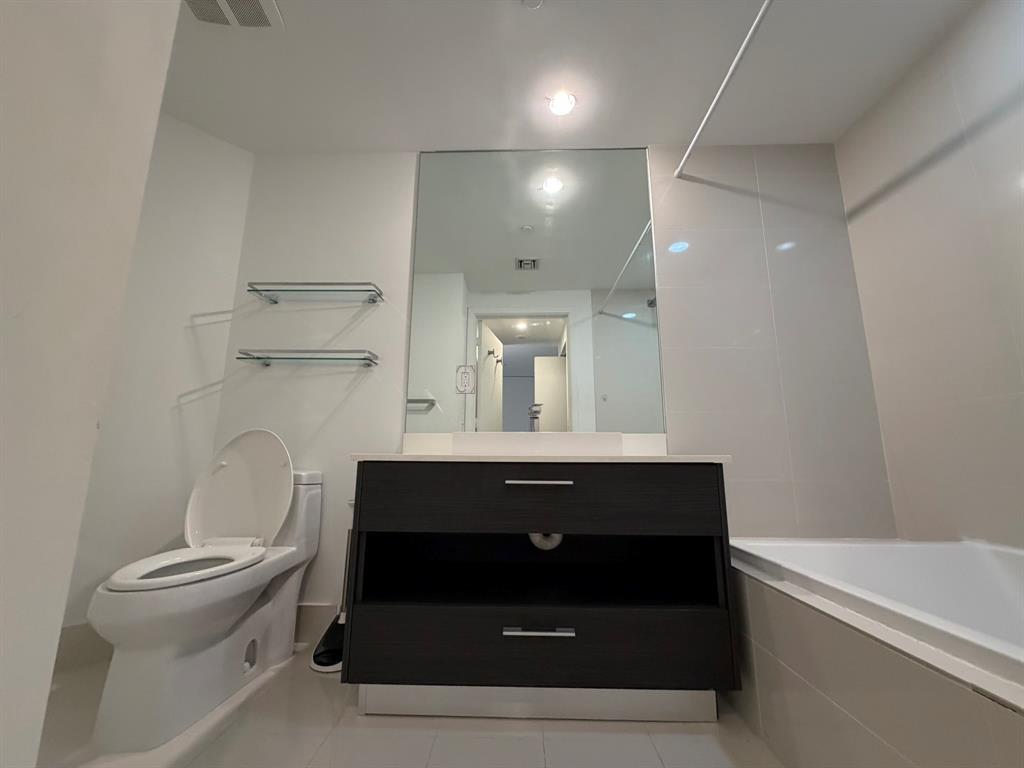 45 Southwest 9th Street, Unit 3110 Miami, FL 33130 - Photo 17 of 19 a bathroom with a sink and a mirror