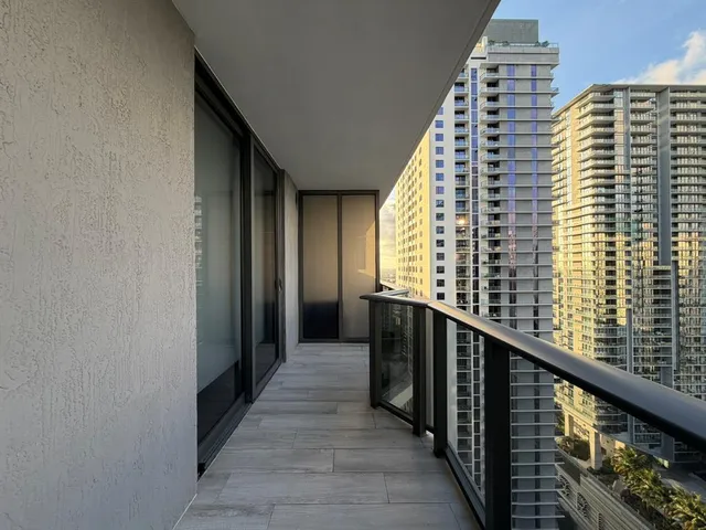a view of a balcony with wooden floor and staircase