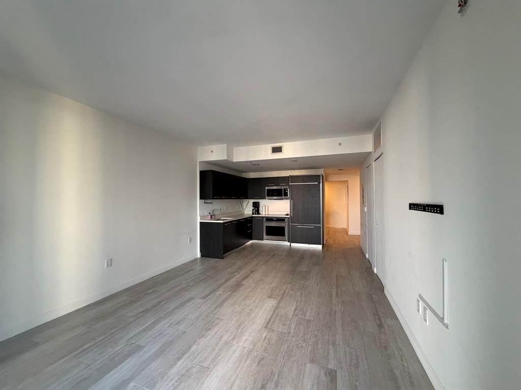 45 Southwest 9th Street, Unit 3110 Miami, FL 33130 - Photo 10 of 19 a view of empty room with wooden floor