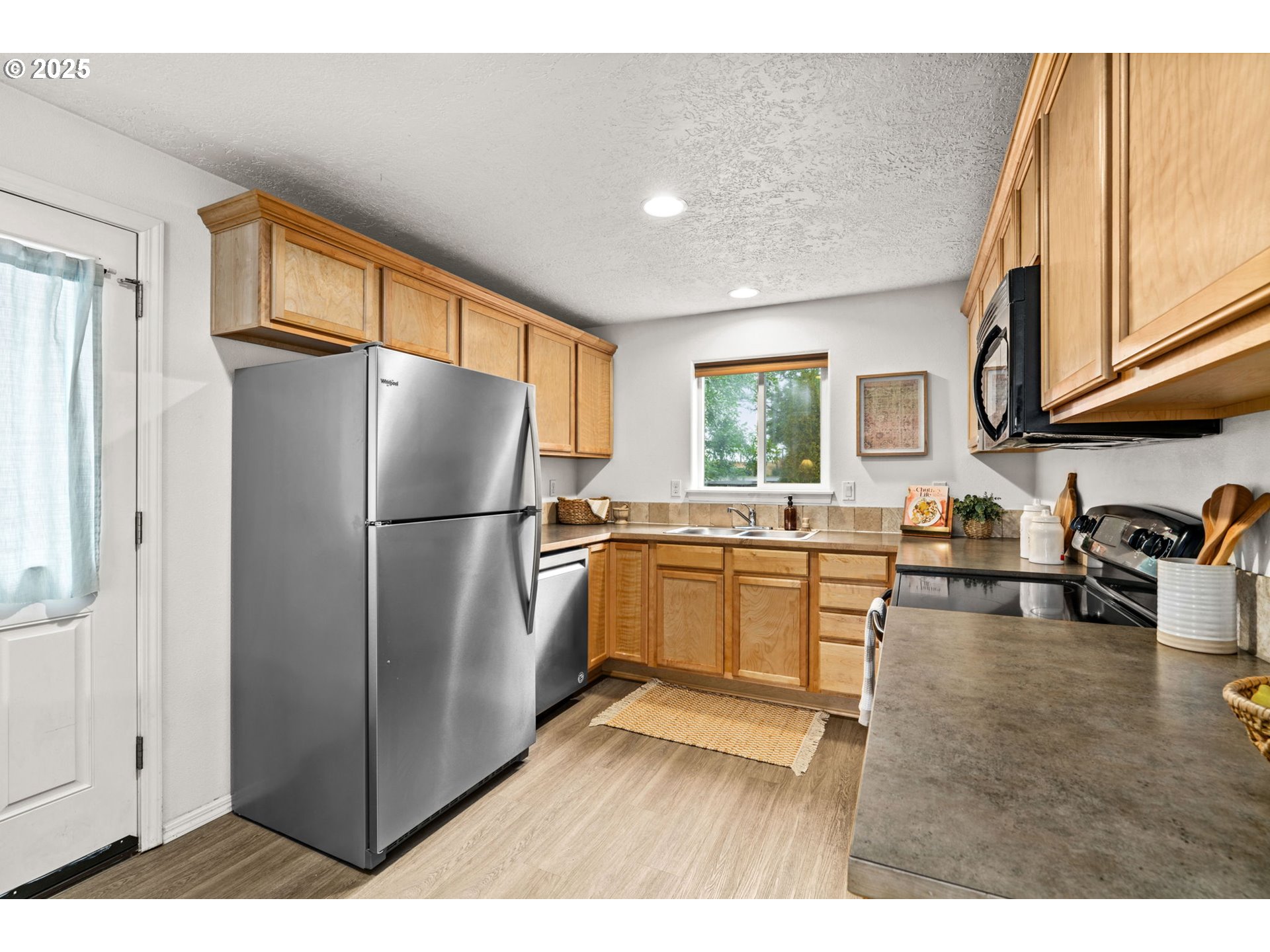 3031 Hummingbird Lane Eugene, OR 97405 - Photo 13 of 28 a kitchen with a refrigerator stove and sink