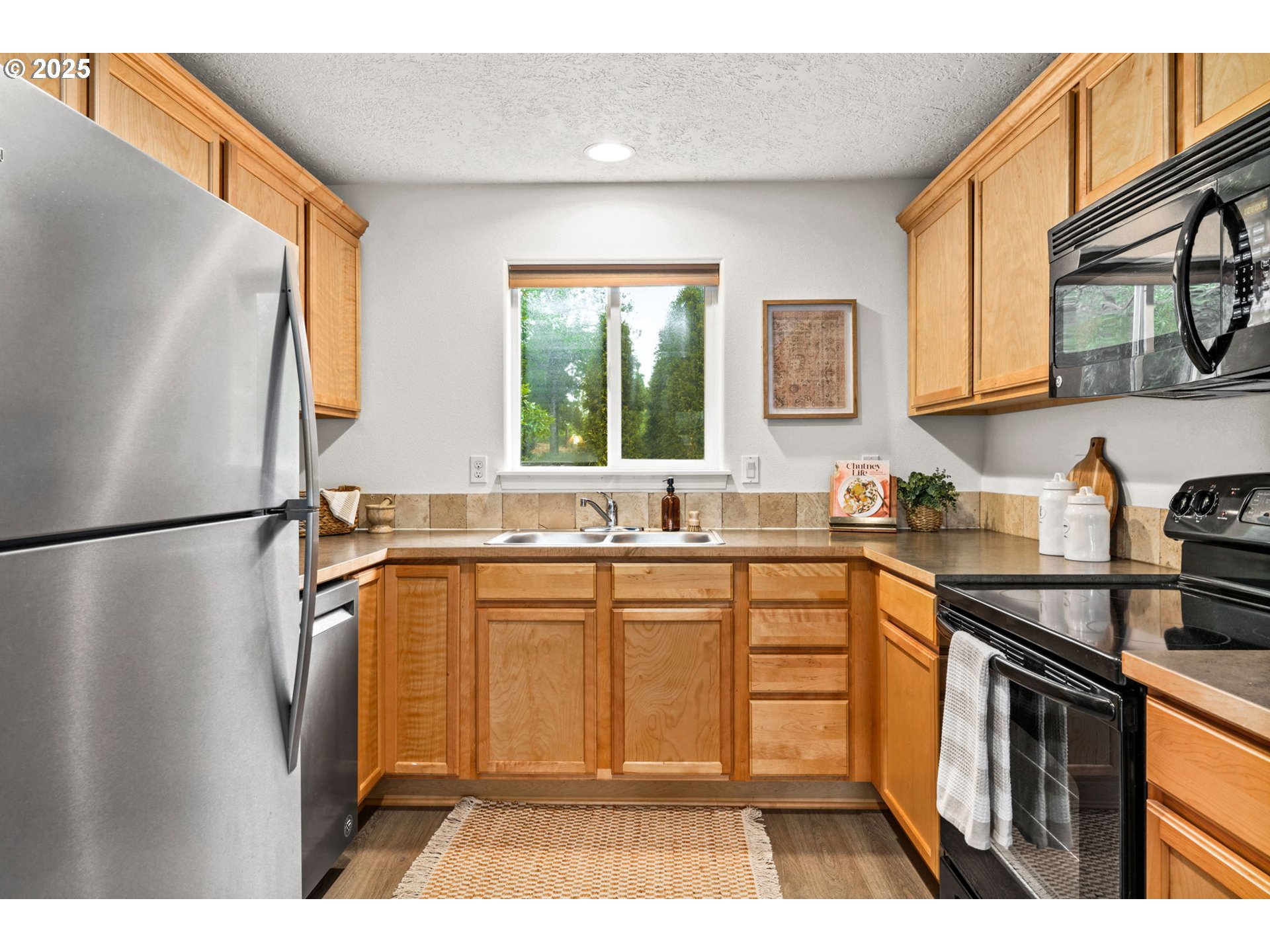3031 Hummingbird Lane Eugene, OR 97405 - Photo 14 of 28 a kitchen with stainless steel appliances a refrigerator sink and cabinets
