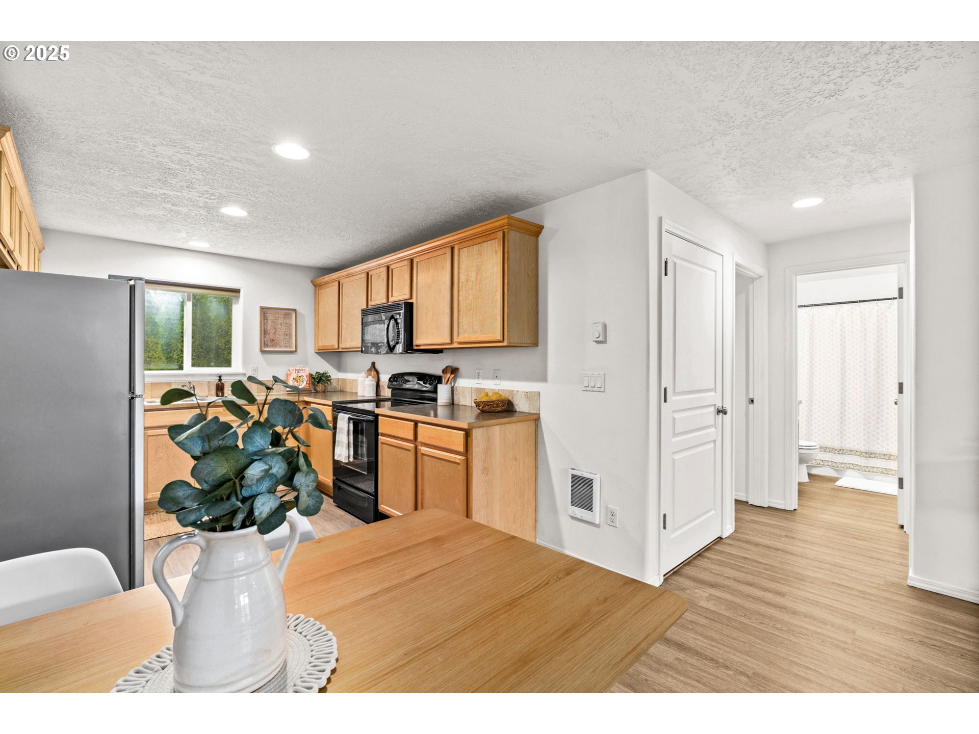 3031 Hummingbird Lane Eugene, OR 97405 - Photo 15 of 28 a kitchen with stainless steel appliances kitchen island granite countertop a refrigerator and a sink