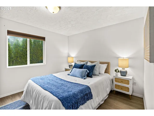 a bedroom with a bed and a night stand