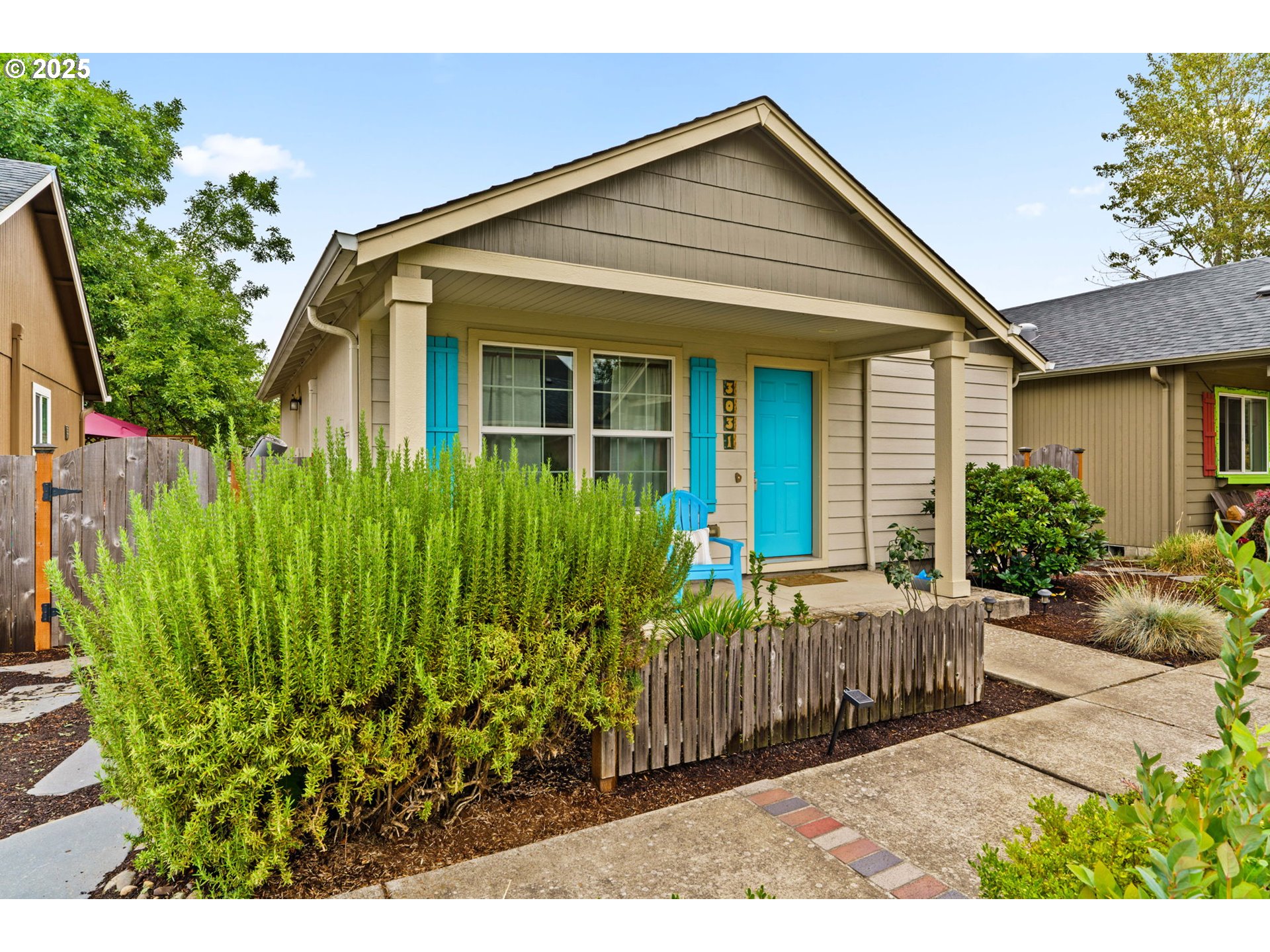 3031 Hummingbird Lane Eugene, OR 97405 - Photo 2 of 28 a view of a house with a small yard and flower plants