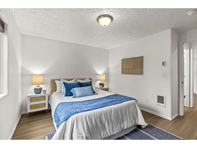 a bedroom with a bed and a night stand