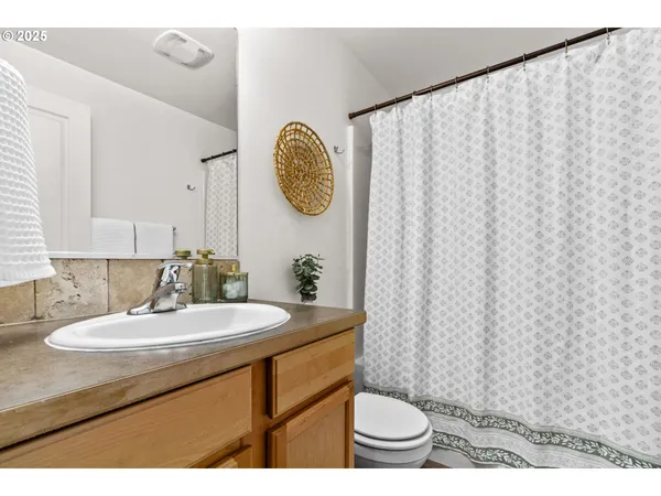a bathroom with a sink toilet and a mirror