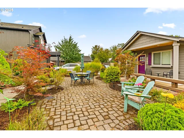 a backyard of a house with yard and outdoor seating