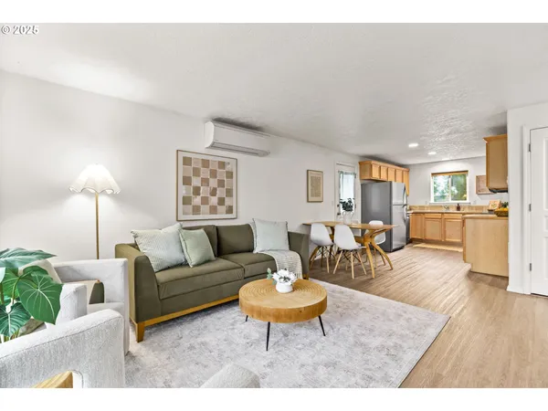 a living room with furniture wooden floor and a table