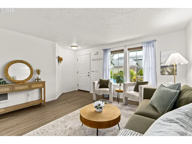 a living room with furniture a window and a potted plant