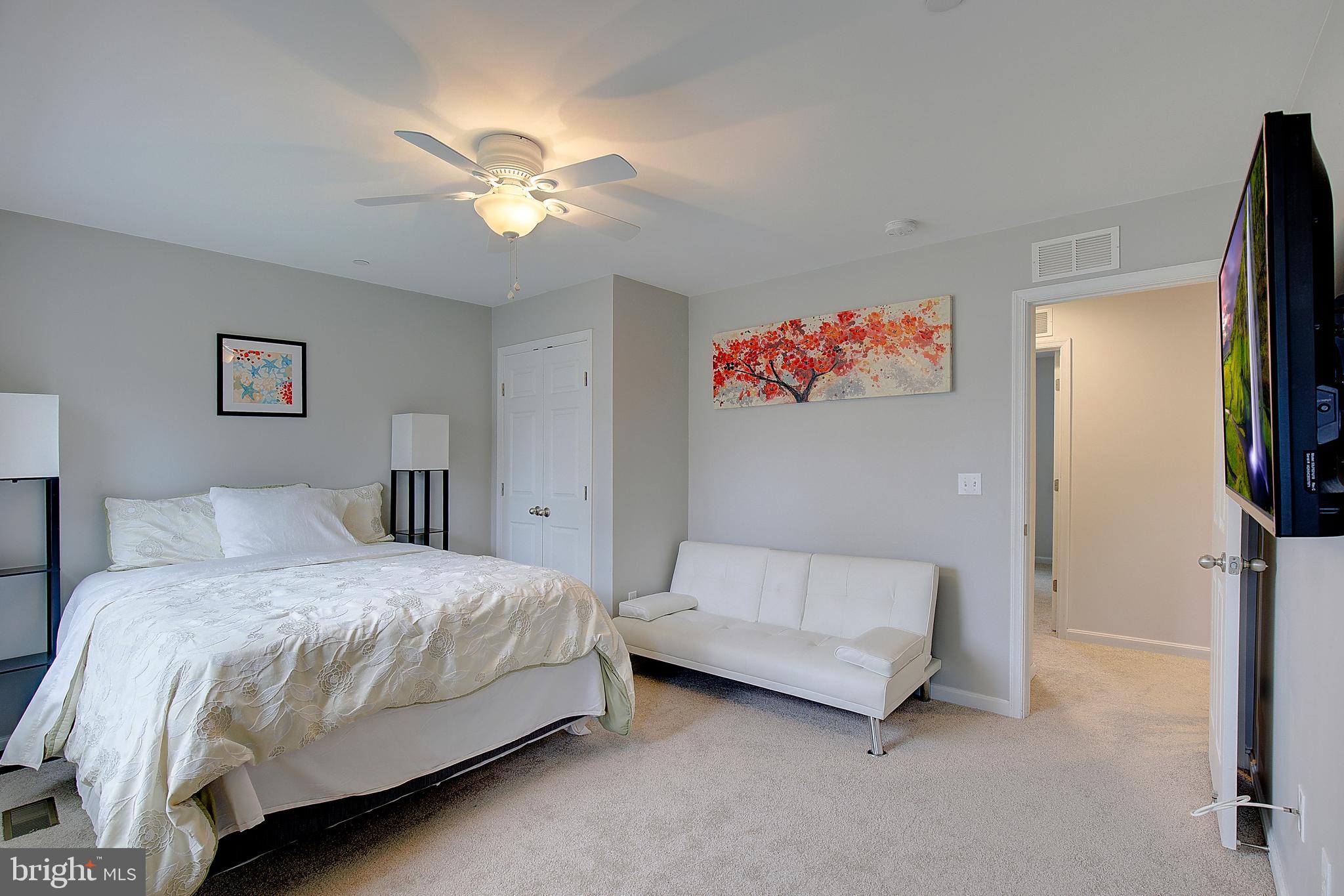 403 Venton Road Edgewater, MD 21037 - Photo 37 of 62 a bedroom with a bed and a chandelier
