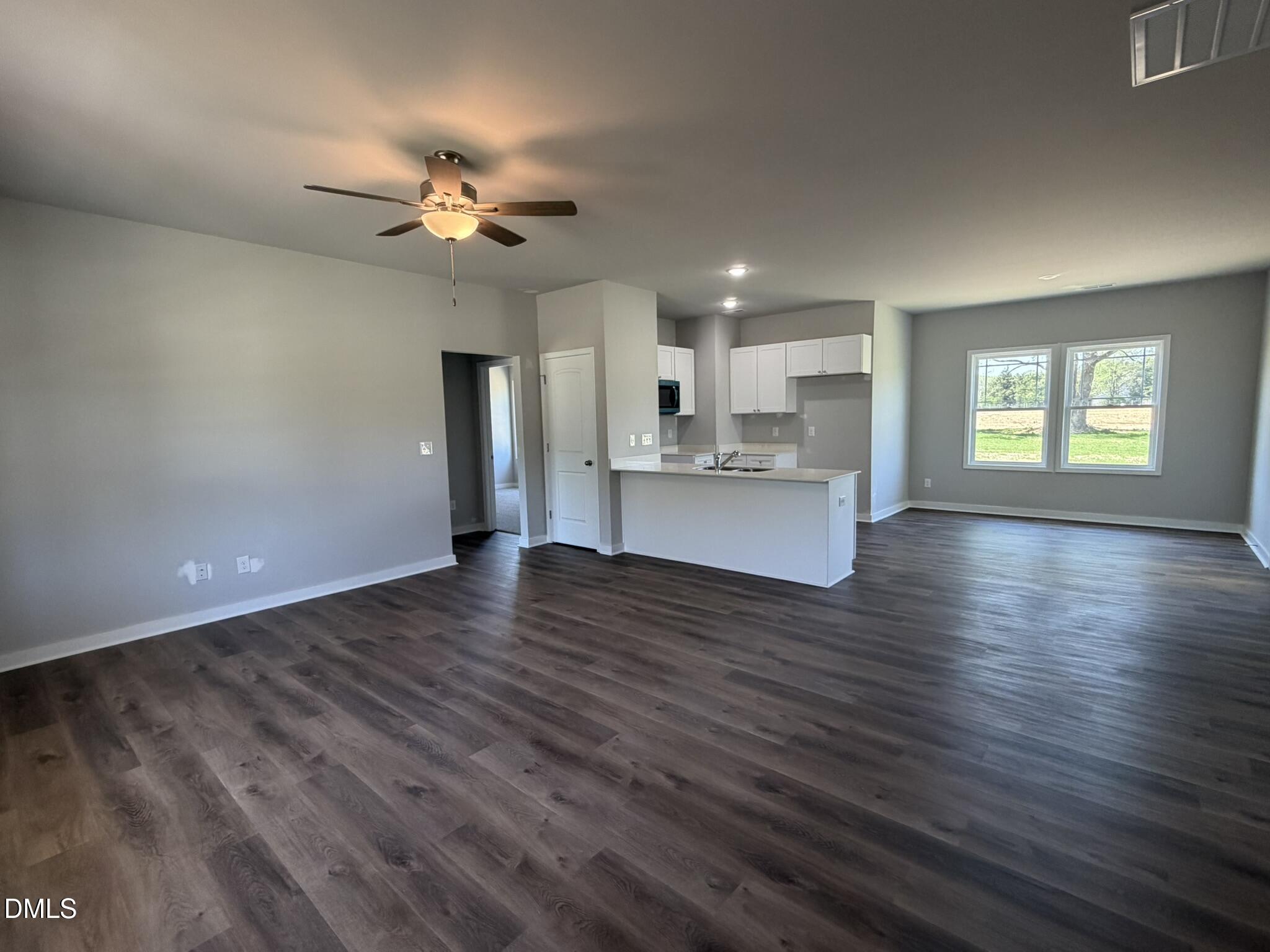 25 Jacobs Ridge Drive Four Oaks, NC 27524 - Photo 2 of 18 a view of a kitchen with a dishwasher a kitchen island hardwood floor and a ceiling fan