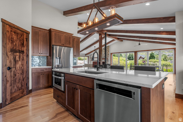 4221 Juniper Circle Alpine, UT 84004 - Photo 3 of 66 Spacious kitchen featuring an expansive island with a white countertop, wood-finish flooring, full-height cabinetry, and stainless steel appliances