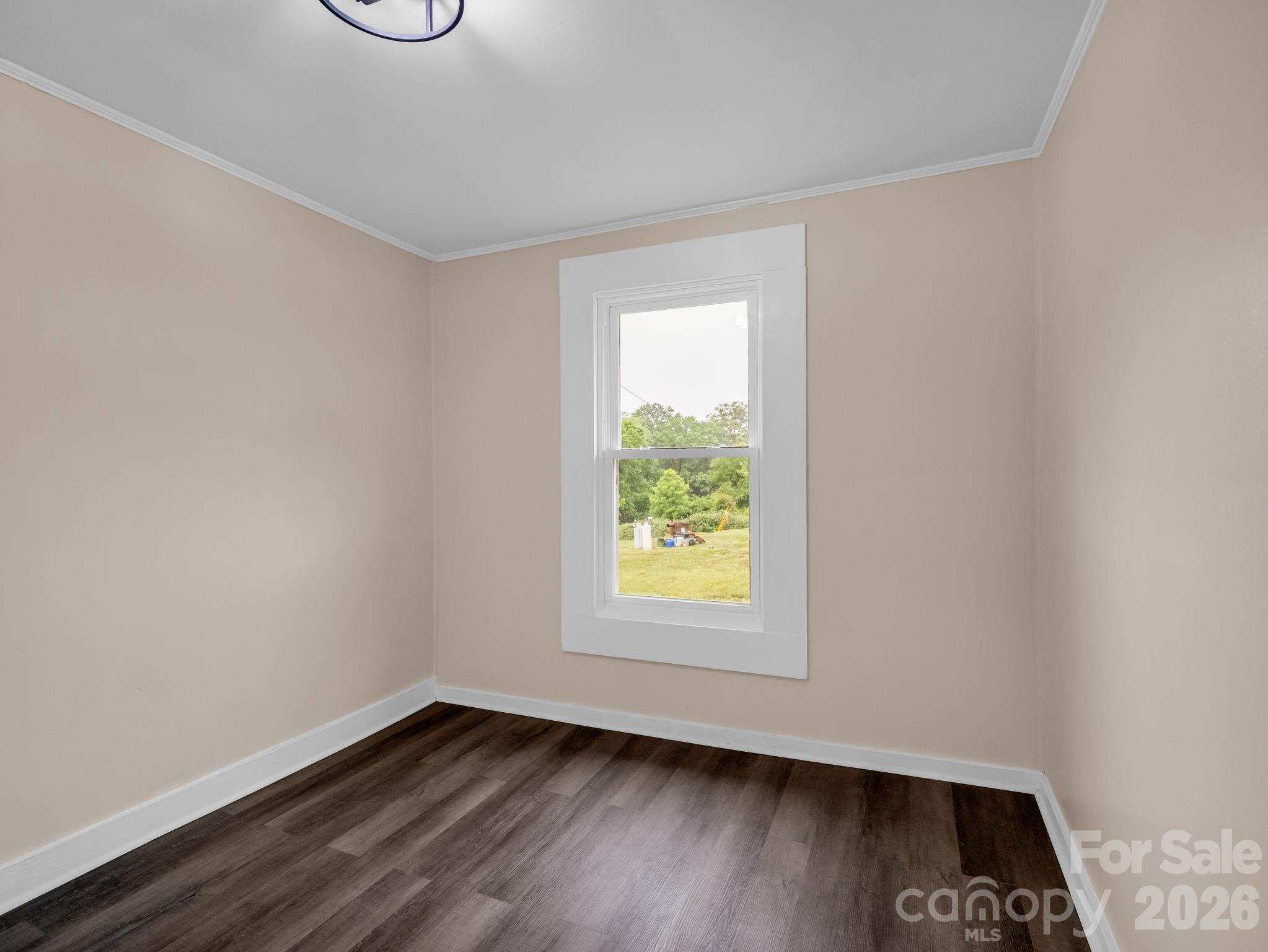 170 Dobbins Road Ellenboro, NC 28040 - Photo 22 of 32 an empty room with wooden floor and windows