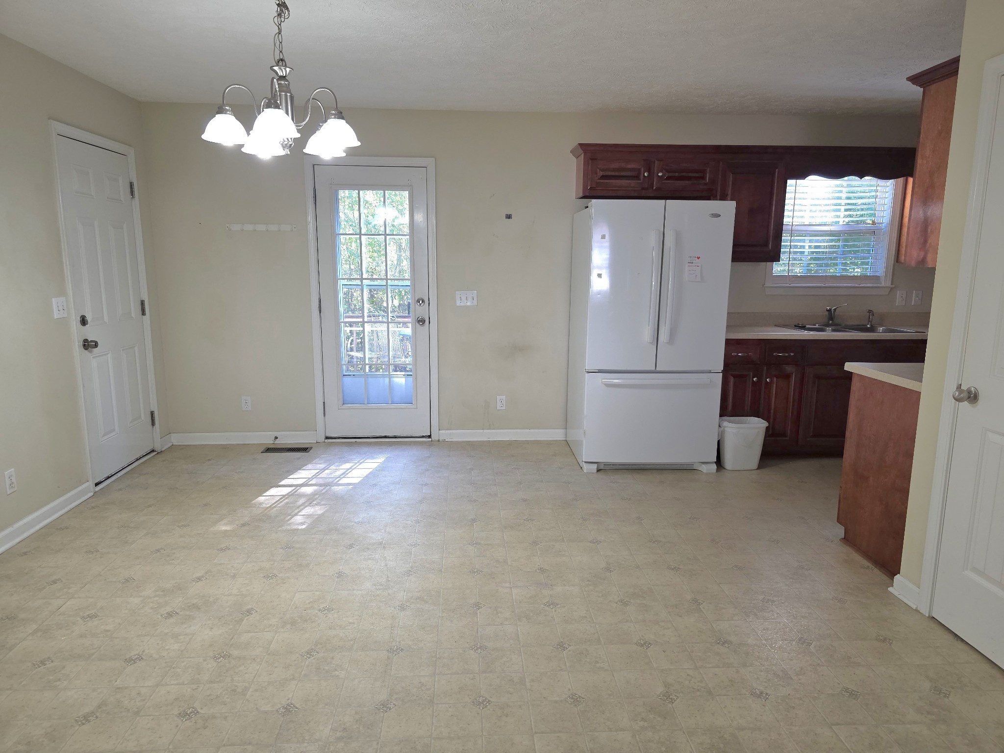 310 Indian Springs Circle Manchester, TN 37355 - Photo 11 of 31 an empty room with chandelier fan and kitchen view