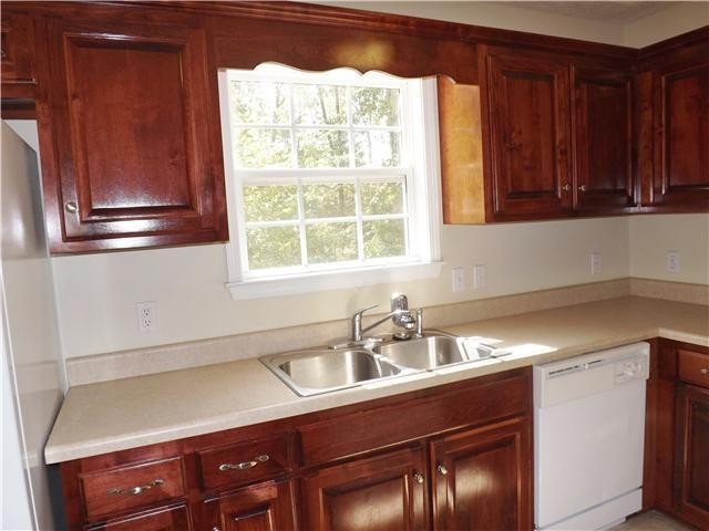 310 Indian Springs Circle Manchester, TN 37355 - Photo 14 of 31 a kitchen with a sink window and cabinets