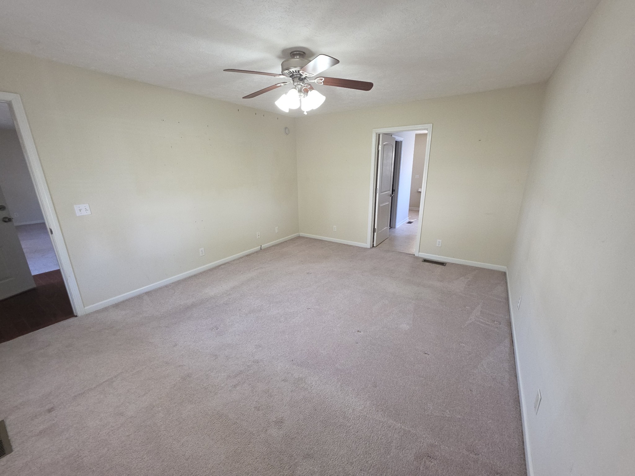 310 Indian Springs Circle Manchester, TN 37355 - Photo 18 of 31 an empty room with chandelier fan and windows