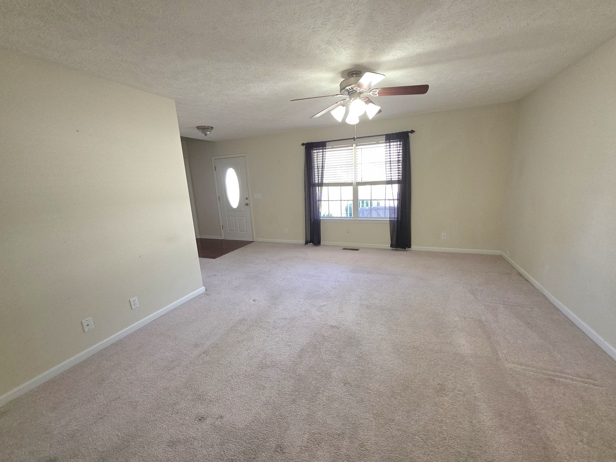 310 Indian Springs Circle Manchester, TN 37355 - Photo 5 of 31 en empty room with windows and chandelier fan