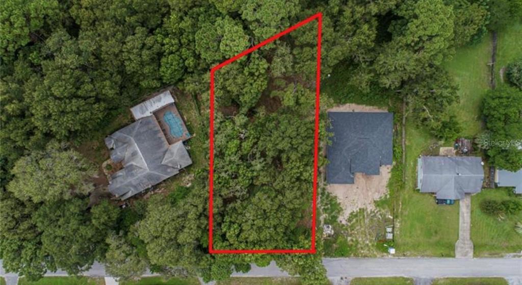 an aerial view of a house with outdoor space and street view