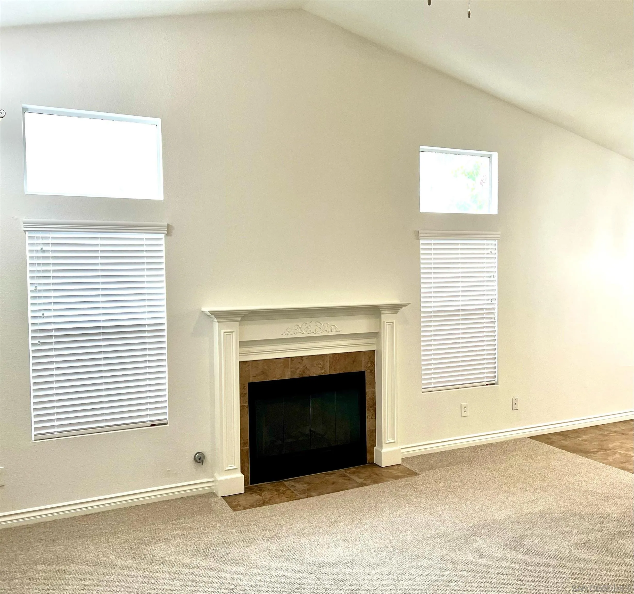 31843 Corte Priego Temecula, CA 92592 - Photo 14 of 23 a view of an empty room with a fireplace and a window