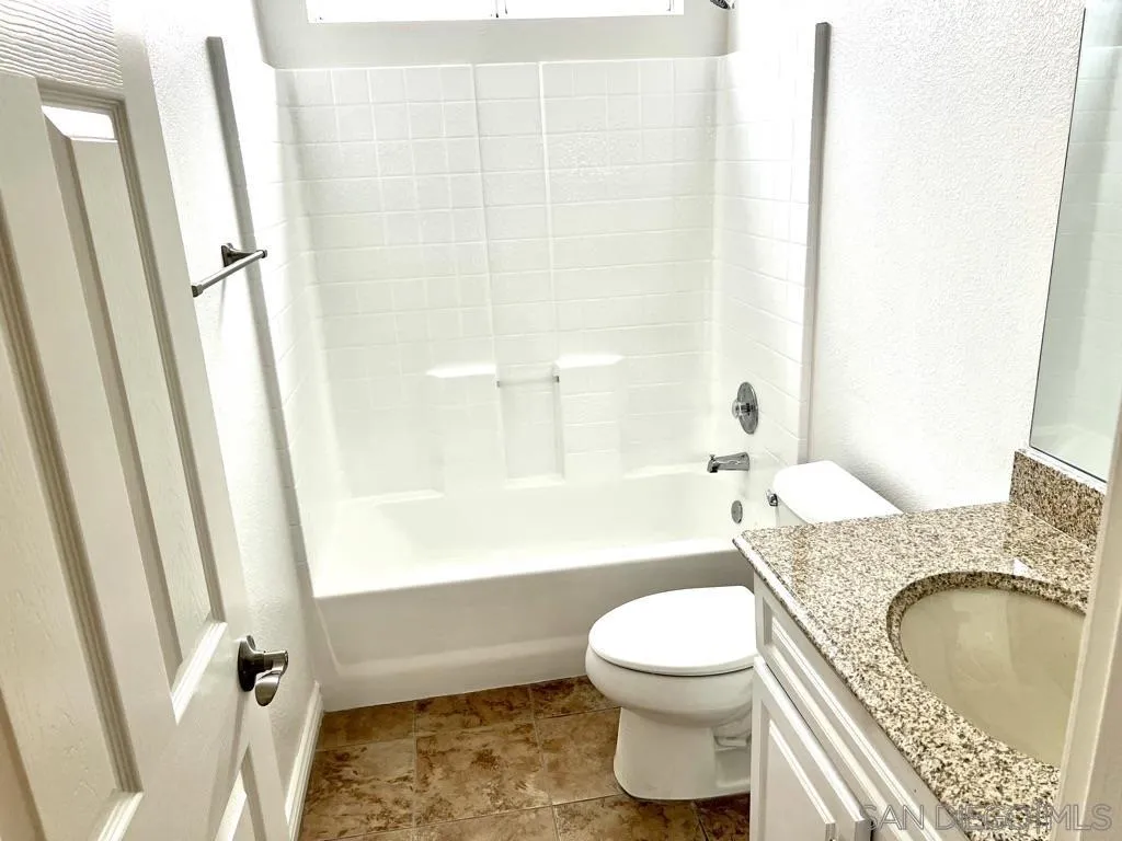 31843 Corte Priego Temecula, CA 92592 - Photo 9 of 23 a bathroom with a granite countertop toilet a sink and a bathtub