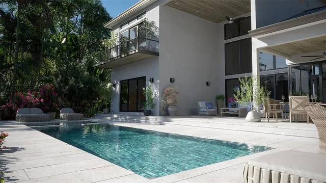 a swimming pool with outdoor seating and yard