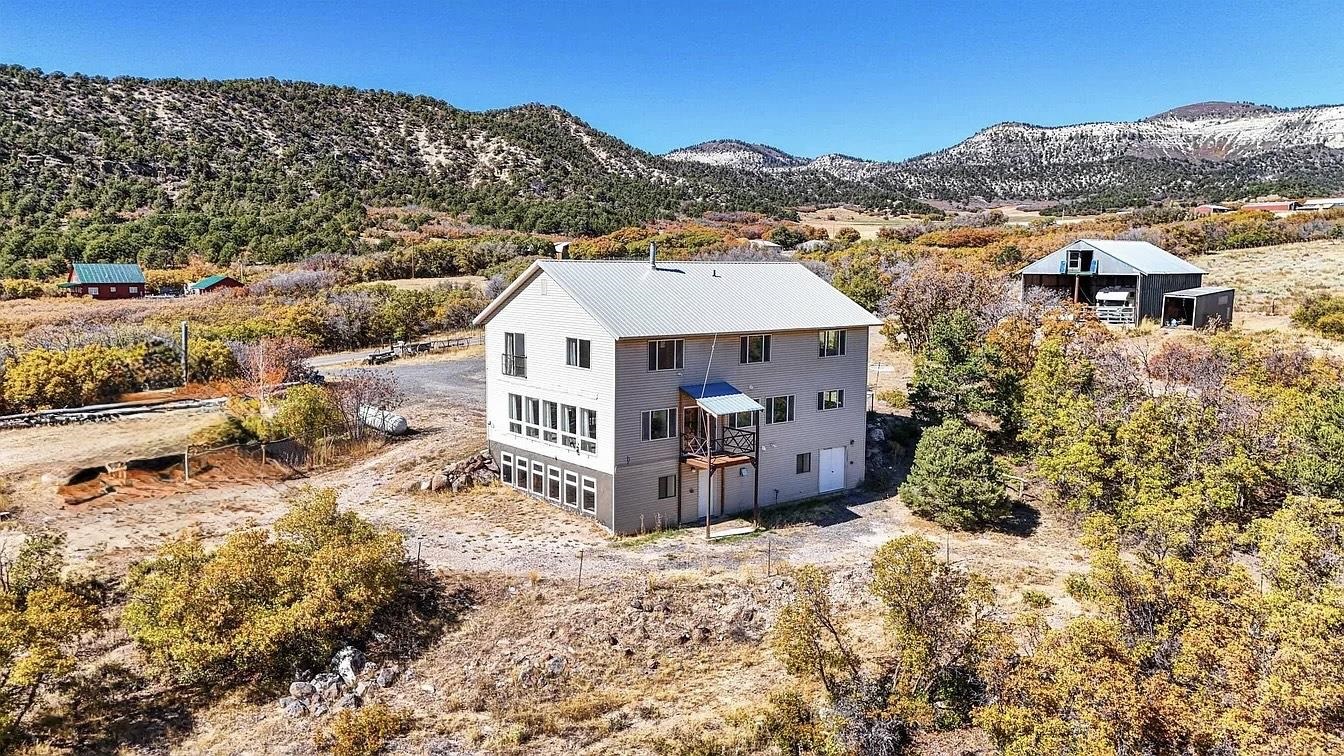 a view of a house with a mountain in the background