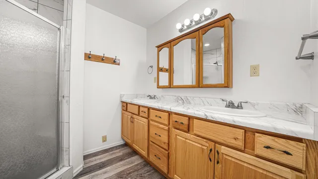 a bathroom with a double vanity sink and a mirror