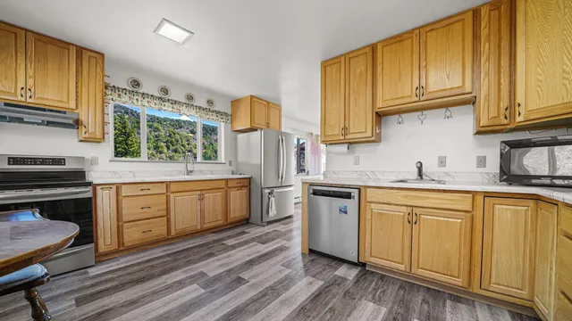 a kitchen with granite countertop wooden cabinets and white appliances