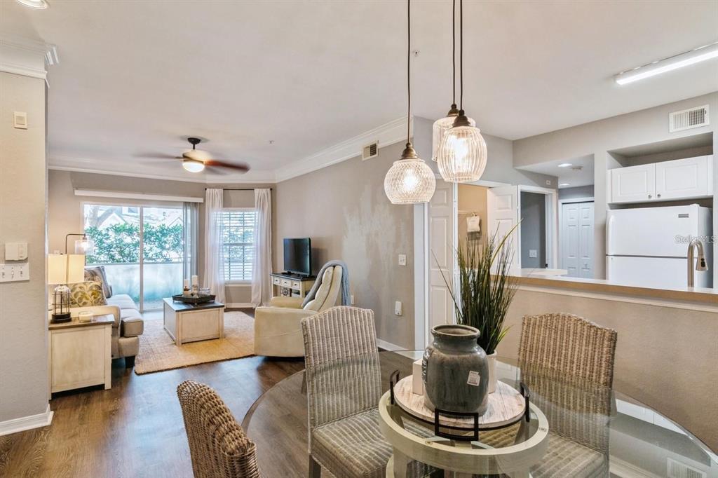 a living room with furniture a flat screen tv and a large window