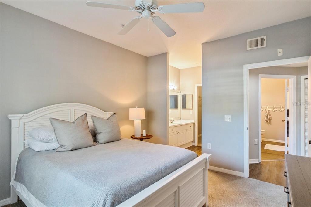 5174 Northridge Road, Unit 111 Sarasota, FL 34238 - Photo 3 of 9 a bedroom with a bed and a chandelier