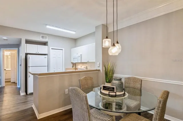 a dining room with furniture and wooden floor