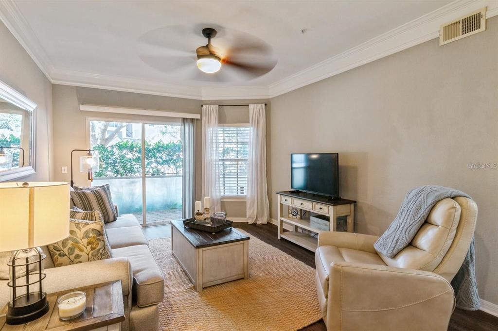 5174 Northridge Road, Unit 111 Sarasota, FL 34238 - Photo 8 of 9 a living room with furniture and a flat screen tv
