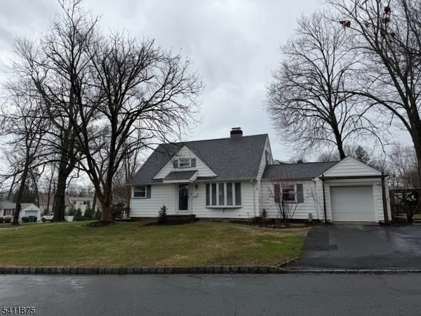 a front view of a house with a yard covered with snow