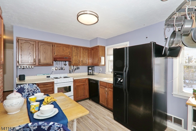 1314 Wood Valley Road Mountainside, NJ 07092 - Photo 14 of 40 a kitchen with stainless steel appliances granite countertop a sink stove and refrigerator