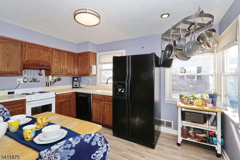 1314 Wood Valley Road Mountainside, NJ 07092 - Photo 15 of 40 a kitchen with a refrigerator and a stove top oven