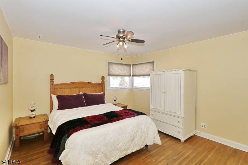 1314 Wood Valley Road Mountainside, NJ 07092 - Photo 19 of 40 a bedroom with a bed and a chandelier